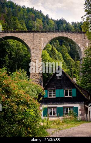Breitnau, Baden-Württemberg, Germany - July 27 2019 : Traditional house in the German Black Forest with wooden roof, green window shutters. The 37m hi Stock Photo