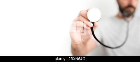 front view of hand of male physician holding stethoscope against white background Stock Photo