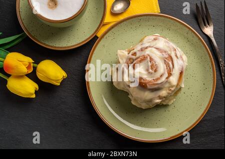 Cinnamon rolls with yellow tulips Stock Photo