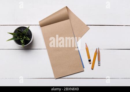 Blank book cover template with page in front side standing on white wood background flat lay. Stock Photo