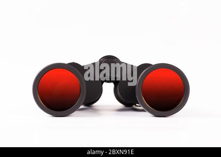 Black binoculars with orange lens isolated on white background Stock Photo