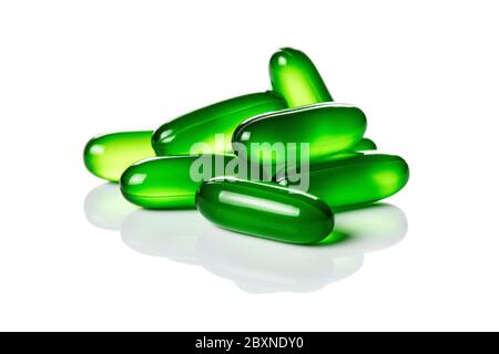 Close up of green soft gel capsules isolated on the white background Stock Photo