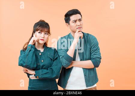 houghtful man and woman consider or plan idea, look at camera lost in thoughts Stock Photo