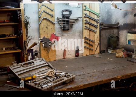A set of working tools on the garage wall and work desk Stock Photo