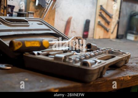 A set of working tools in the old garage and work desk Stock Photo