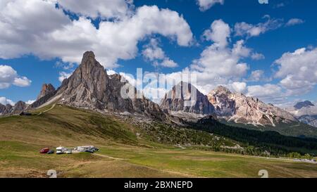Panoramic view of Giau Mountain Pass (Cortina d'Ampezzo, Italy) with dolomites mountain range against blue sky on the background Stock Photo