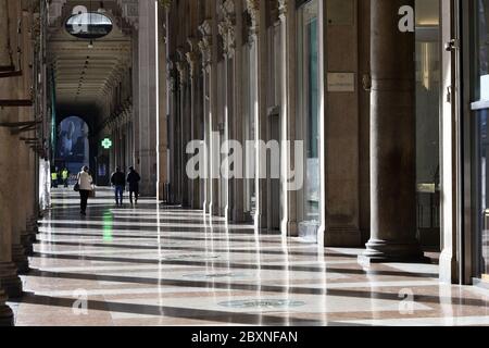 Empty Duomo square's colonnade due to the Coronavirus lockdown, with the Duomo cathedral, in Milan. Stock Photo