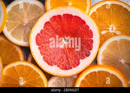 Sliced Grapefruit on the white wood background In the studio Stock Photo