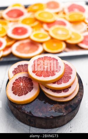 Sliced Grapefruit on the white wood background In the studio Stock Photo