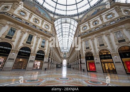 The emptiness of Galleria Vittorio Emanuele with shops closed during the lockdown caused by the Covid-19 in Milan, Italy. Stock Photo