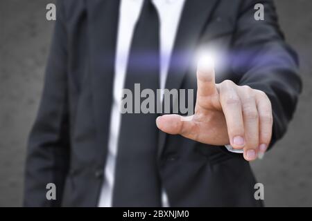 Businessman finger pressing an imaginary screen. Idea for business, technology, internet and networking. Stock Photo