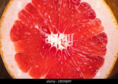 Sliced Grapefruit on the white wood background In the studio Stock Photo