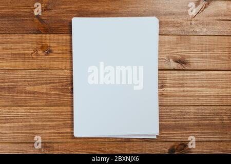 Top view of modern desk office workplace with  a4 paper. Blank branding template. Photo blank form. Mock up for portfolio design. Stock Photo