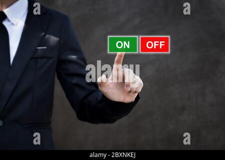 Businessman pressing ON OFF button. Concept of technology and business. Stock Photo