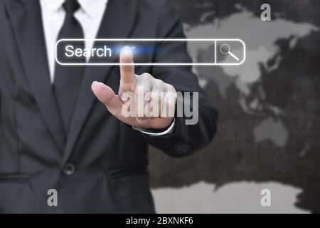 Businessman clicking internet search page on virtual screen. Concept of searching with pressing button. Elements of this image furnished by NASA Stock Photo
