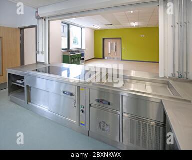 Kitchen in a newly completed London secondary school. View across servery into dining hall. Stock Photo