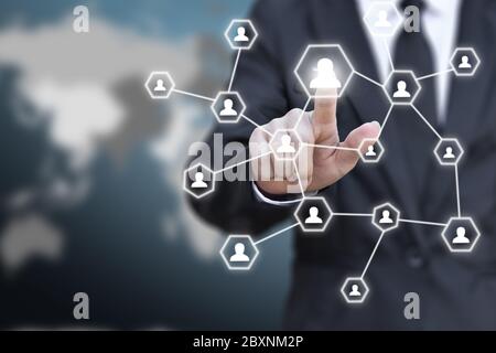 Businessman pressing network icon button on a virtual map world background. Concept of business communication. Elements of this image furnished by NAS Stock Photo