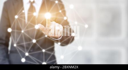 Businessman hand pressing on virtual screen in the network connection. Concept of global communication in business. Stock Photo