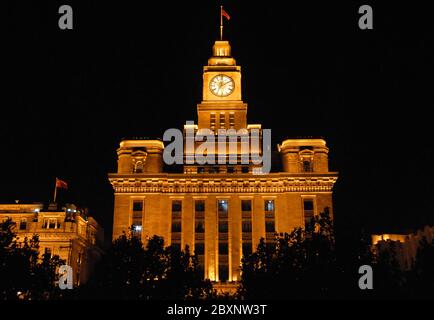 The Custom House on the Bund in Shanghai, China. The Bund is a riverfront area in central Shanghai with many historical concession era buildings. Stock Photo