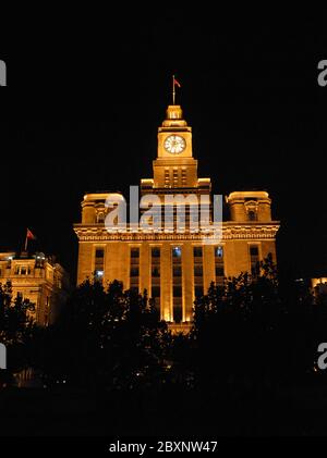 The Custom House on the Bund in Shanghai, China. The Bund is a riverfront area in central Shanghai with many historical concession era buildings. Stock Photo
