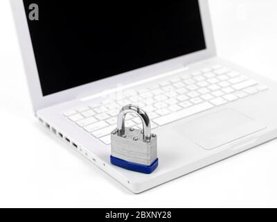 A laptop computer and a padlock isolaterd against a white background higlighting computer security Stock Photo