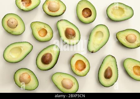 Slices Of Avocado Cut In Half On Table Stock Photo