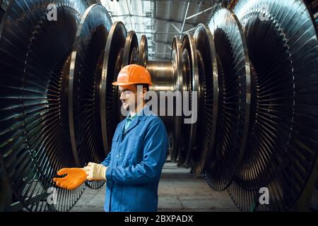 Engineer checks turbine impeller vanes, factory Stock Photo