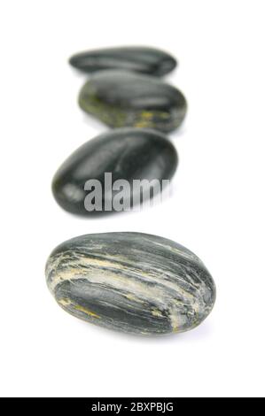 Black river rocks isolated against a white background Stock Photo