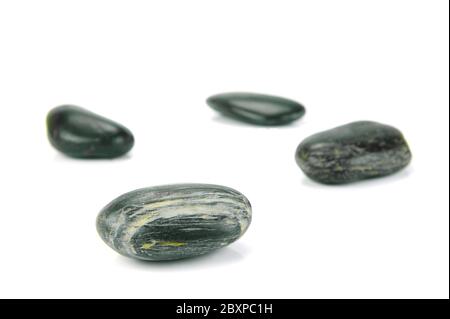 Black river rocks isolated against a white background Stock Photo