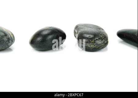 Black river rocks isolated against a white background Stock Photo