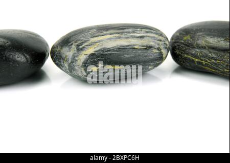 Black river rocks isolated against a white background Stock Photo