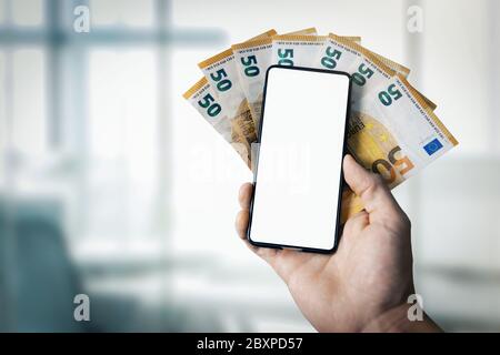 online banking, ecommerce and digital wallet concept - hand holding euro money and mobile phone with blank screen in hand Stock Photo