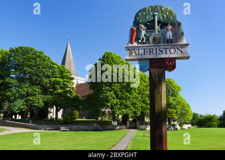 St Andrew's Church and village sign, Alfriston, East Sussex, England, UK Stock Photo