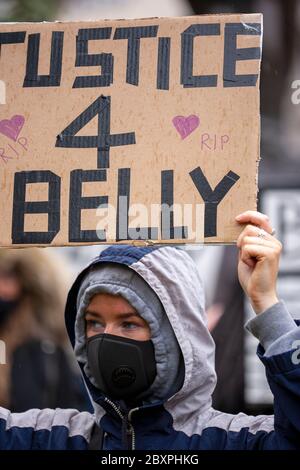 Protester, wearing a face mask and hooded top, holds up a 'Justice 4 Belly' sign at the Black Lives Matter UK protest, Parliament Square UK Stock Photo