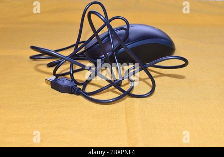 Wired three button USB optical mouse PC pointing device which uses light-emitting diode Precise cursor control helps edit documents and browse the web Stock Photo