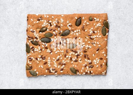 Whole grain rye crispbread cracker isolated on grey concrete background Stock Photo