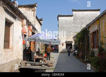 Xidi Ancient Town in Anhui Province, China. Old town of Xidi with historical buildings showing a street stall and a restaurant Stock Photo