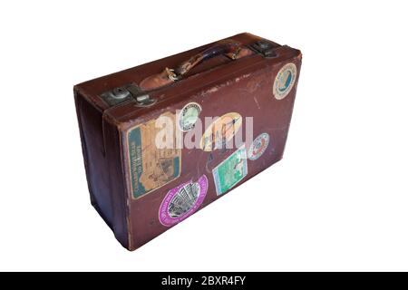 Old battered leather suitcase with worn travel stickers Stock Photo