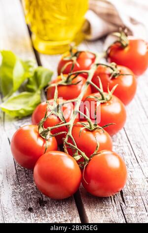 Red cherry tomatoes on wooden table. Stock Photo