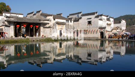 Hongcun Ancient Town in Anhui Province, China. Architecture of Lexu Hall and old buildings reflected in the water of Moon Pond in Hongcun. Stock Photo