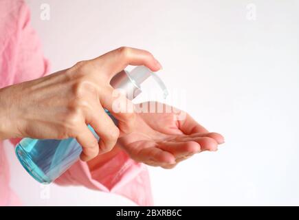 Close Up of Female Hand Pressing Alcohol Hand Rubbing Gel for Hand Hygiene Stock Photo