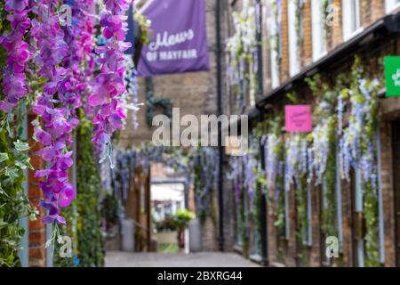 Lancashire Court, quaint mews street hidden away in Mayfair usually bustling with people dining al fresco, but now eerily quiet during Covid lockdown Stock Photo