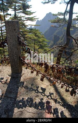 Huangshan Mountain in Anhui Province, China. Lovers' locks attached to iron chains by lovers representing their eternal love. A Huangshan tradition. Stock Photo