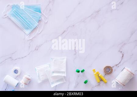 Flat lay of some medical supplies against a white marble background with plenty of copy space Stock Photo