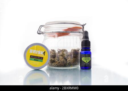 Suffolk, UK June 01 2020: A jar of cannabis along side some CBD products which are becoming ever more popular to the general public. Stock Photo