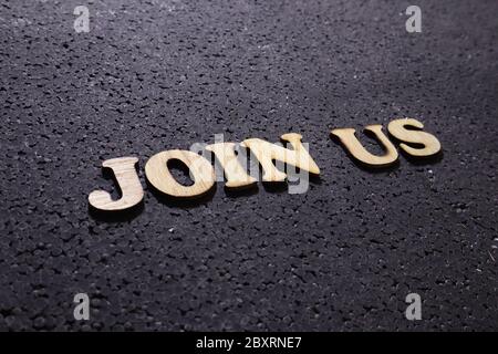 Join us, business motivational inspirational quotes, wooden words typography lettering concept on black background Stock Photo