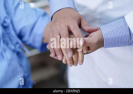 Holding Touching hands Asian senior or elderly old lady woman patient with love, care, helping, encourage and empathy at nursing hospital ward : healt Stock Photo