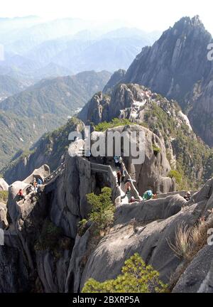 Huangshan Mountain in Anhui Province, China. The steep path to the summit of Lotus Peak on Huangshan with Yuping Hotel behind. Stock Photo