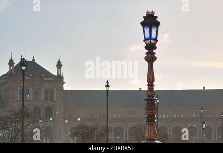 Ceramic tiled lantern and Plaza de Espana ancient architecture on background. Soap bubbles flying in the air against sky. Beloved famous touristic pla Stock Photo