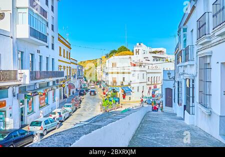 ARCOS, SPAIN - SEPTEMBER 23, 2019: The cityscape with narrow streets, heavy traffic, white housing of Pueblo Blanco (white town), shops and cafes, loc Stock Photo